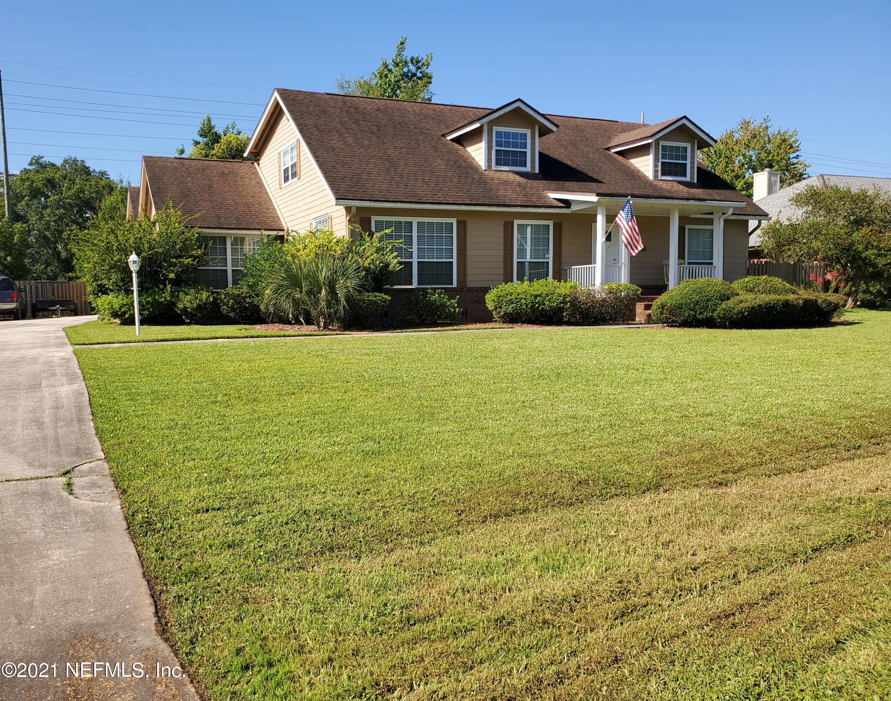 3047 Nautilus Road Middleburg, FL 32068 - Photo 1 of 37 a front view of a house with a garden and lake view