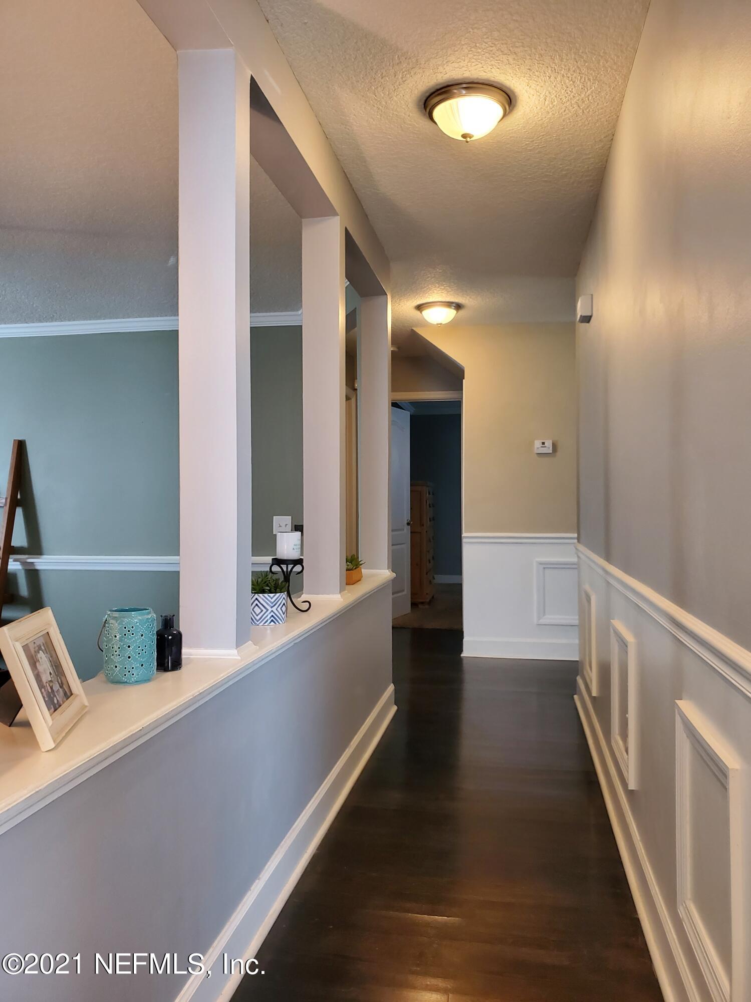 3047 Nautilus Road Middleburg, FL 32068 - Photo 7 of 37 a view of a hallway with wooden floor and staircase