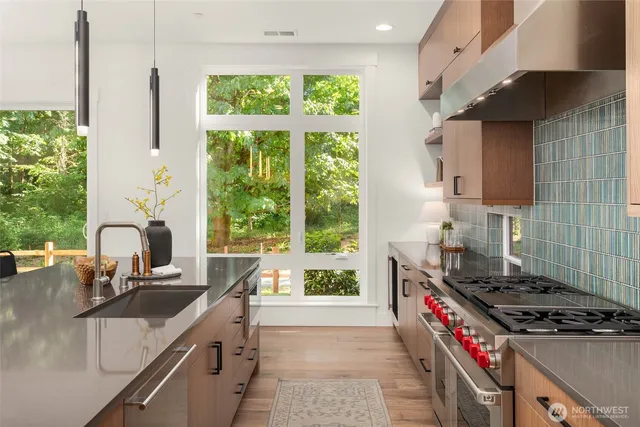 a kitchen with a stove a sink and a wooden cabinets