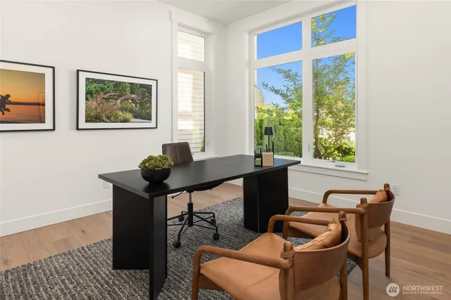 a view of a workspace with furniture and a window