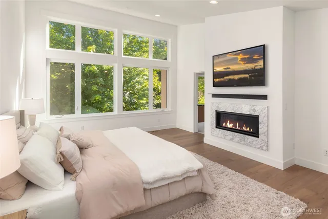 a spacious bedroom with a balcony a bed and a fireplace