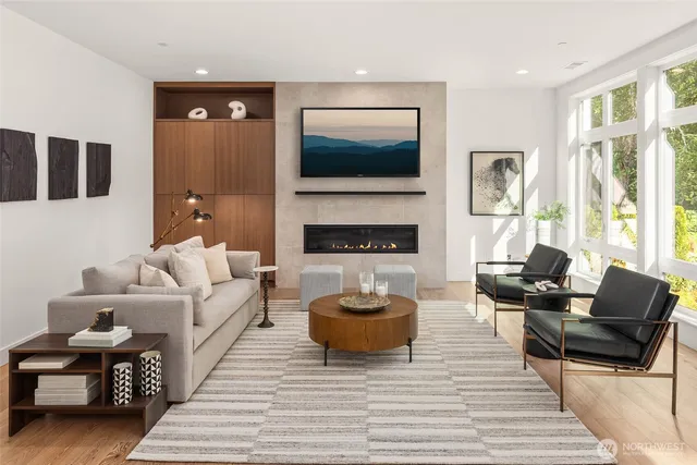 a living room with furniture a flat screen tv and a fireplace