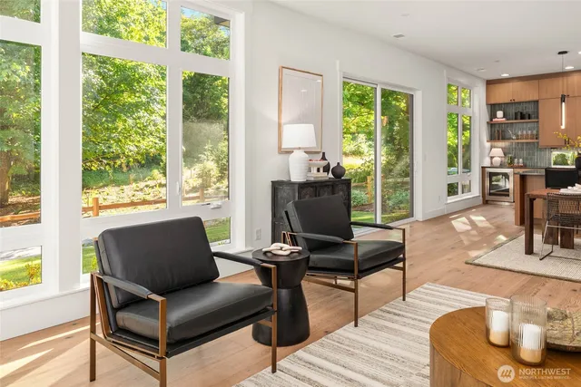 a living room with furniture and a floor to ceiling window