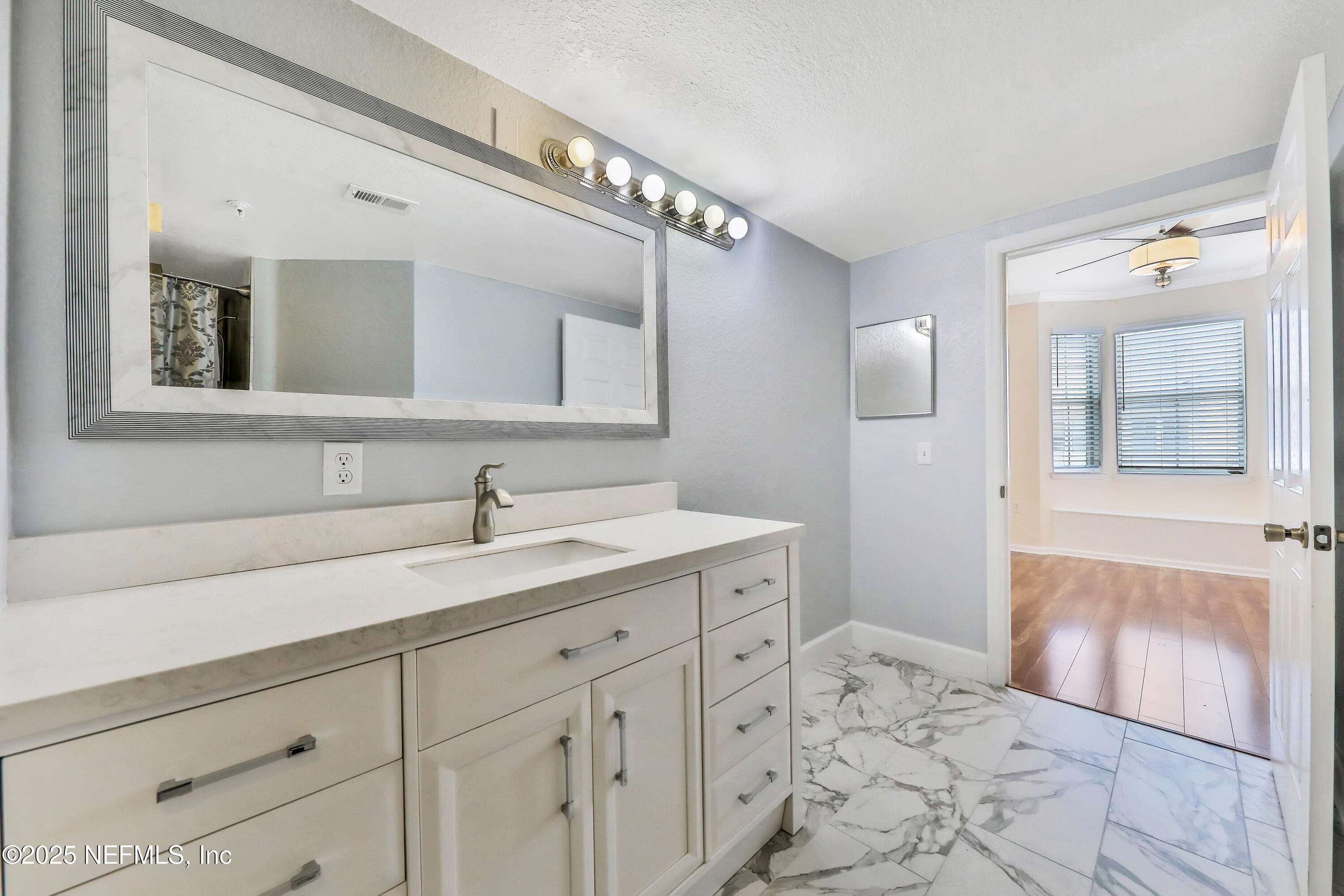 8550 Touchton Road, Unit 2133 Jacksonville, FL 32216 - Photo 16 of 41 a bathroom with a sink and a mirror