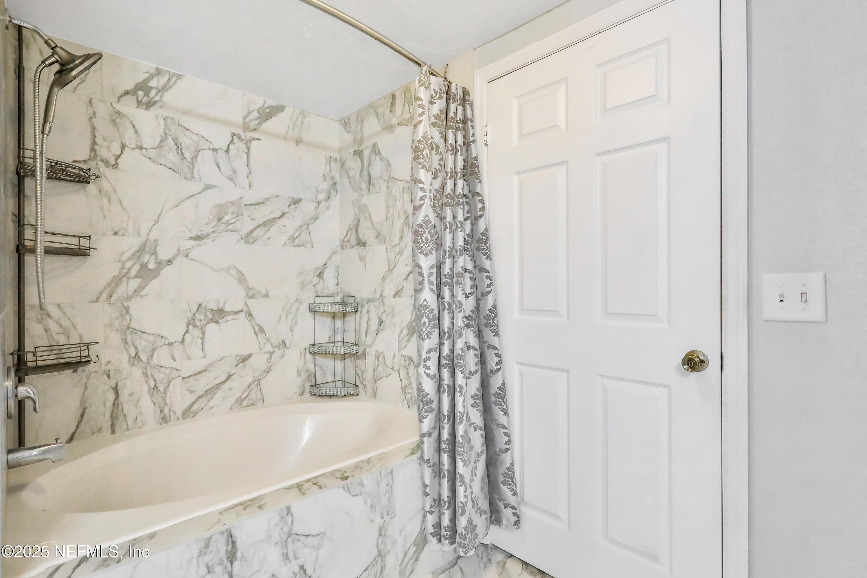 8550 Touchton Road, Unit 2133 Jacksonville, FL 32216 - Photo 17 of 41 a bathroom with a bathtub and shower