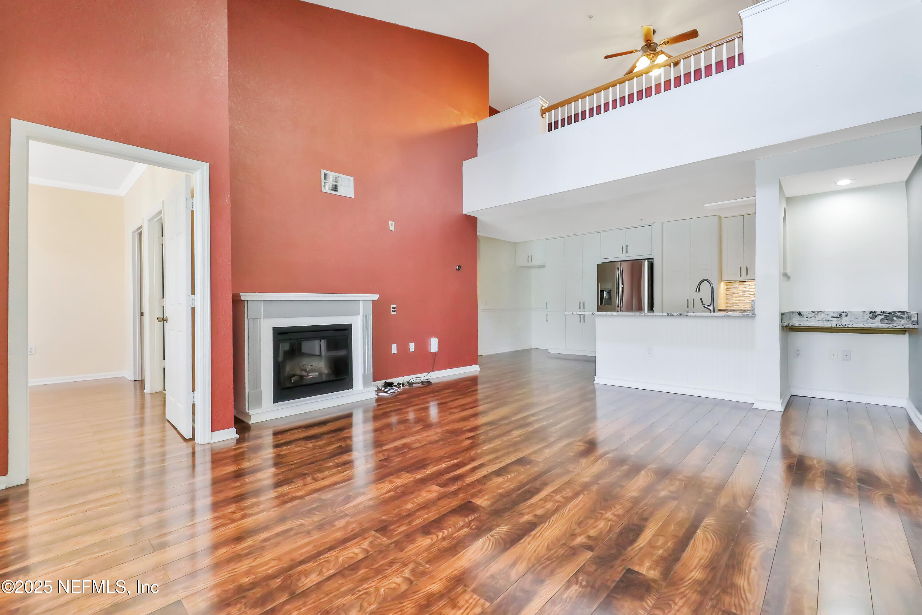 8550 Touchton Road, Unit 2133 Jacksonville, FL 32216 - Photo 7 of 41 a view of a livingroom with wooden floor and a kitchen
