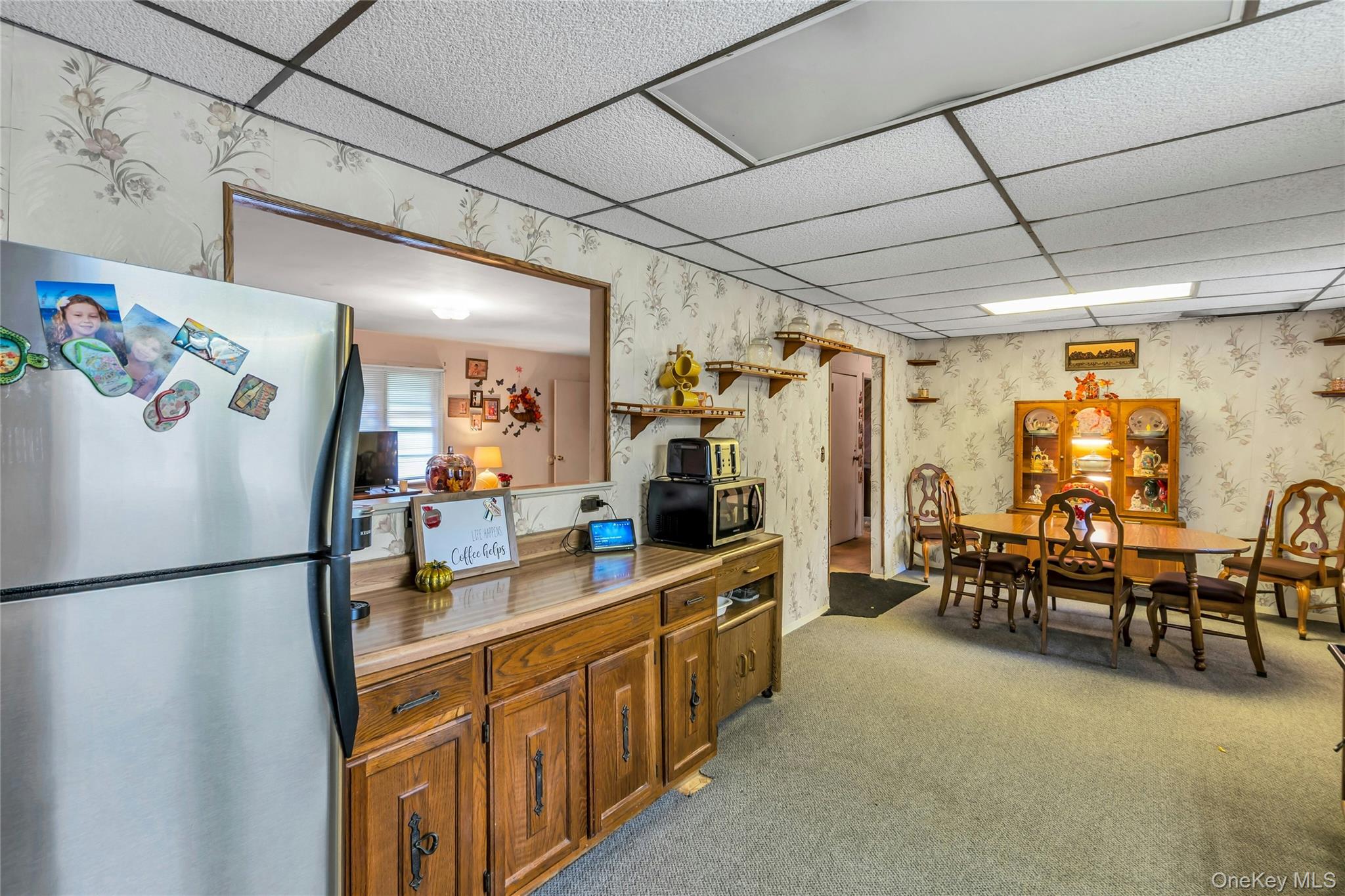 769 Meadow Road Smithtown, NY 11787 - Photo 11 of 27 a kitchen with refrigerator and chairs