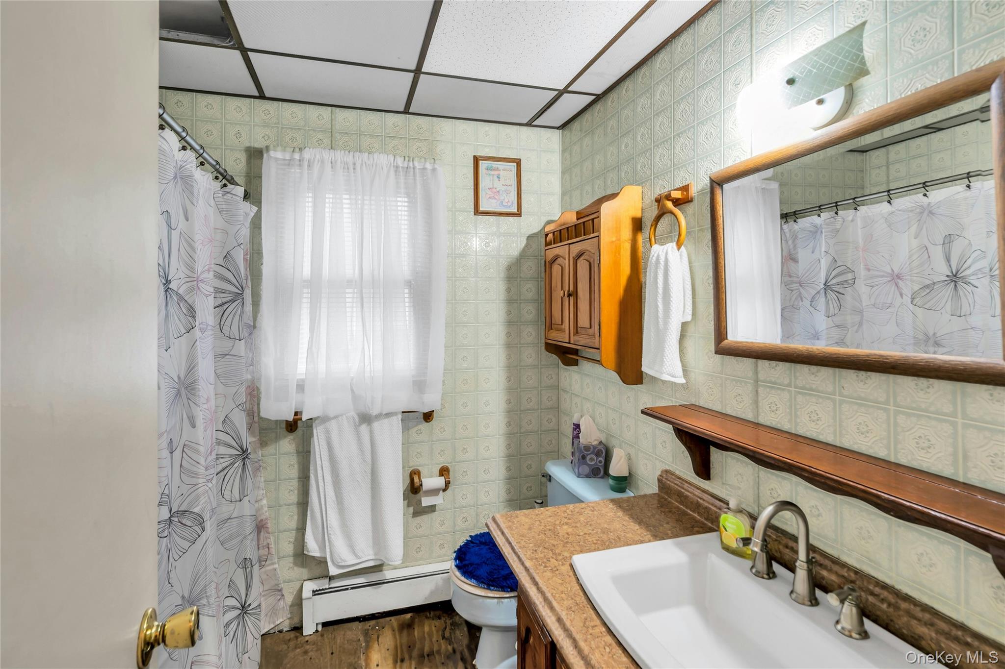 769 Meadow Road Smithtown, NY 11787 - Photo 17 of 27 a bathroom with a sink and a mirror