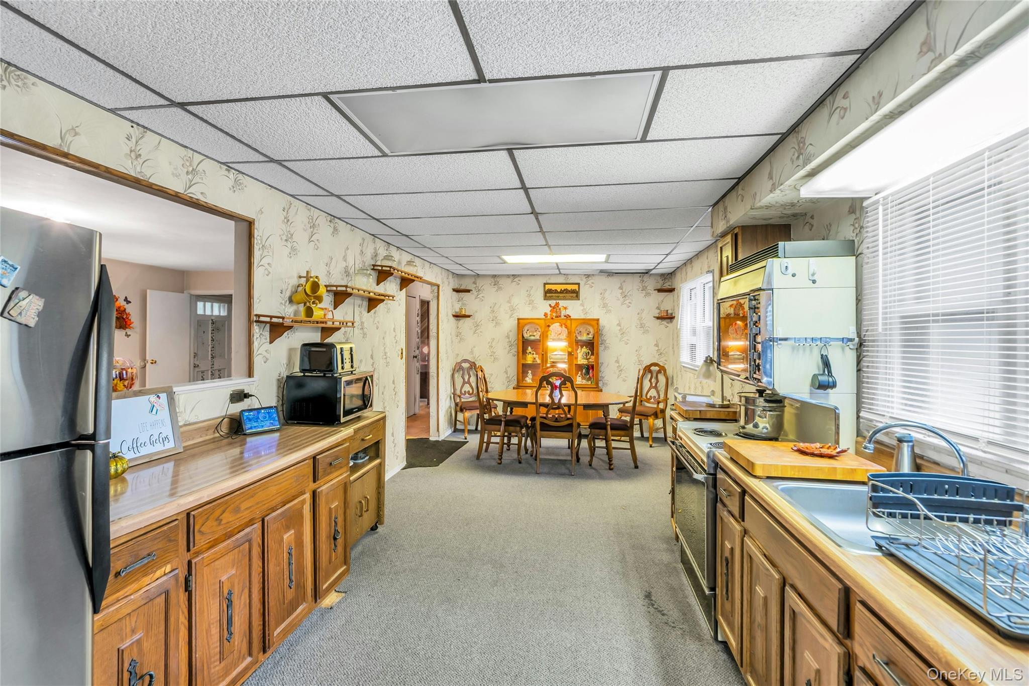 769 Meadow Road Smithtown, NY 11787 - Photo 10 of 27 a large white kitchen with a large window