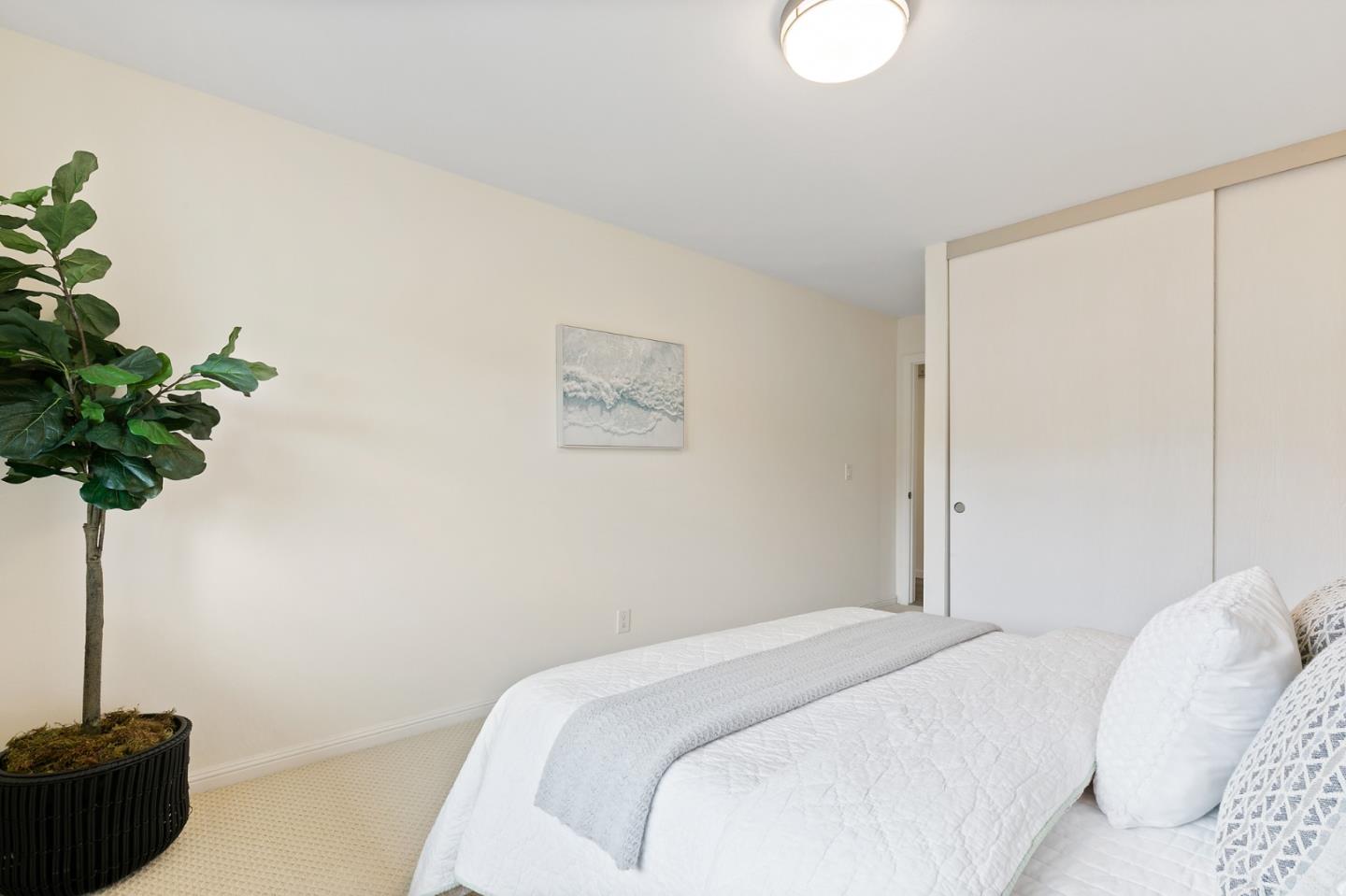 100 East Middlefield Road, Unit 2F Mountain View, CA 94043 - Photo 21 of 29 a bedroom with a bed and a potted plant