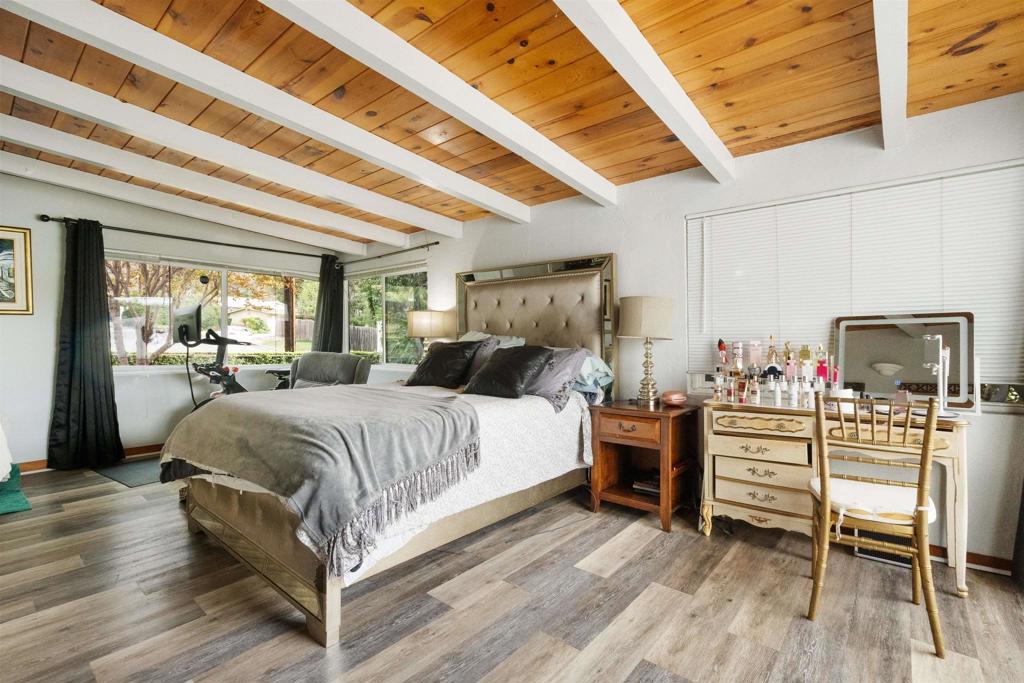 14102 Tobiasson Road Poway, CA 92064 - Photo 16 of 23 a spacious bedroom with a bed and wooden floor