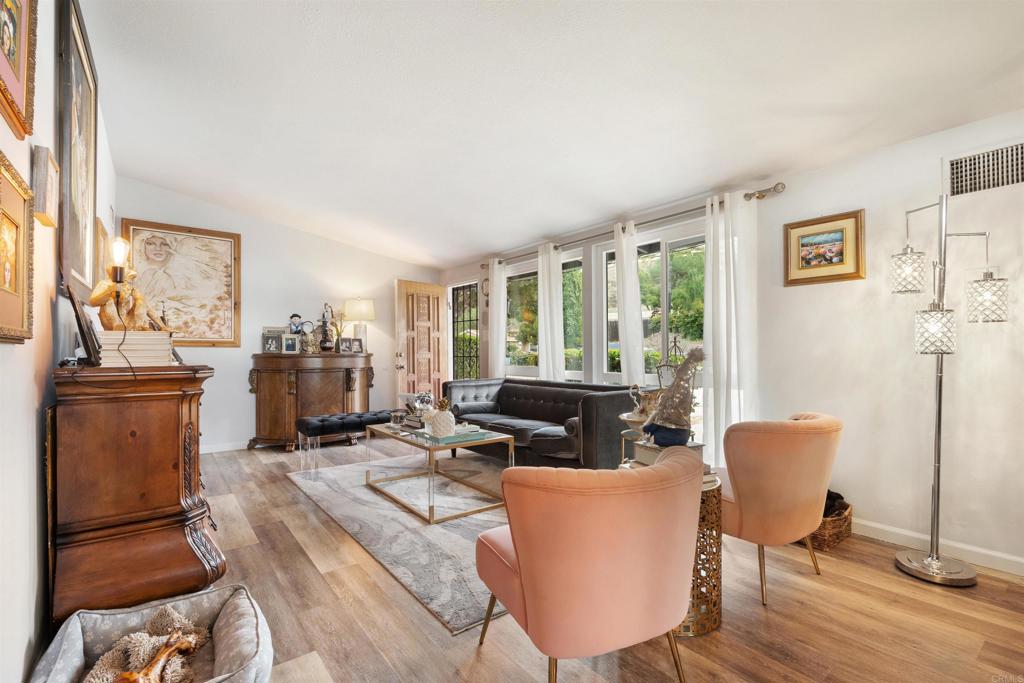 14102 Tobiasson Road Poway, CA 92064 - Photo 3 of 23 a living room with furniture a large window and wooden floor