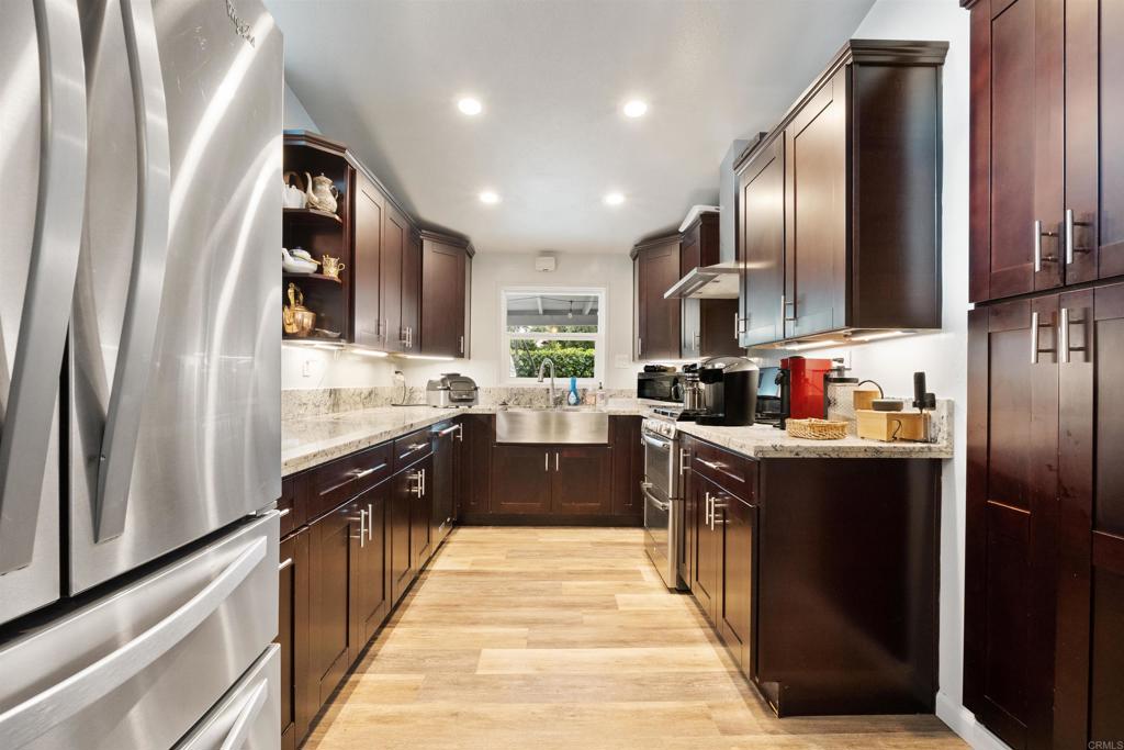 14102 Tobiasson Road Poway, CA 92064 - Photo 7 of 23 a kitchen with stainless steel appliances granite countertop refrigerator a sink dishwasher a stove and a refrigerator