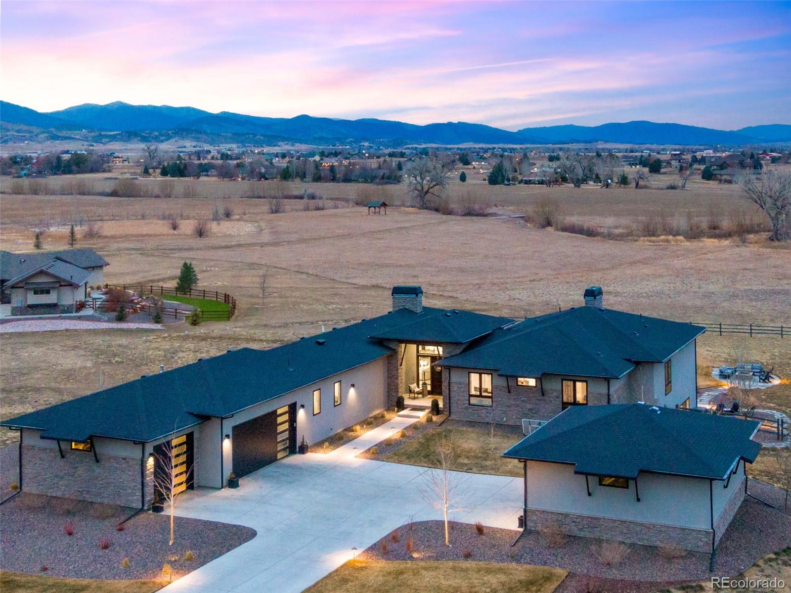 3210 Mallard Creek Road Berthoud, CO 80513 - Photo 1 of 40 a view of a lake with a table and chairs