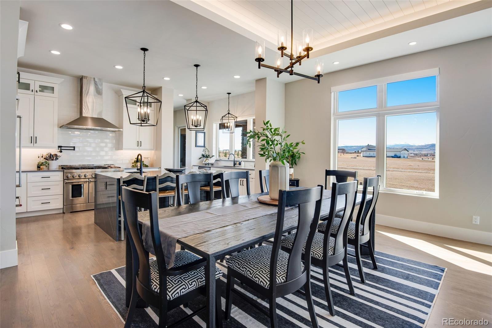 3210 Mallard Creek Road Berthoud, CO 80513 - Photo 15 of 40 a view of a dining room with furniture and wooden floor
