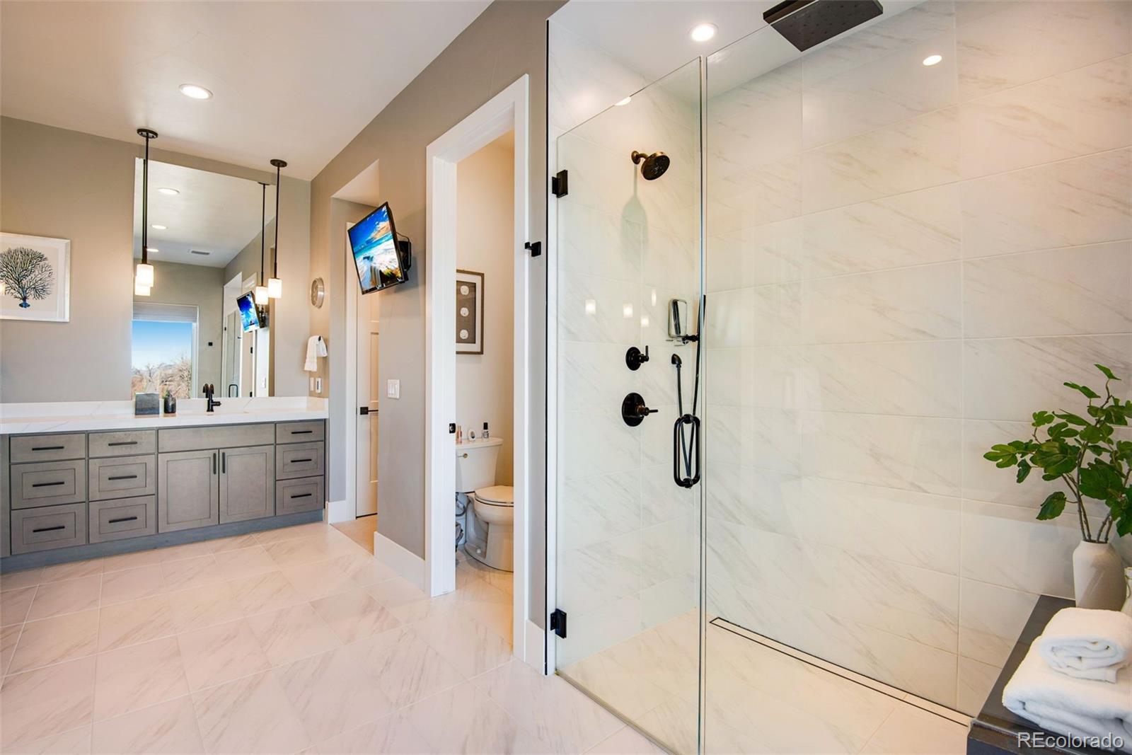 3210 Mallard Creek Road Berthoud, CO 80513 - Photo 28 of 40 a bathroom with a granite countertop sink mirror and shower