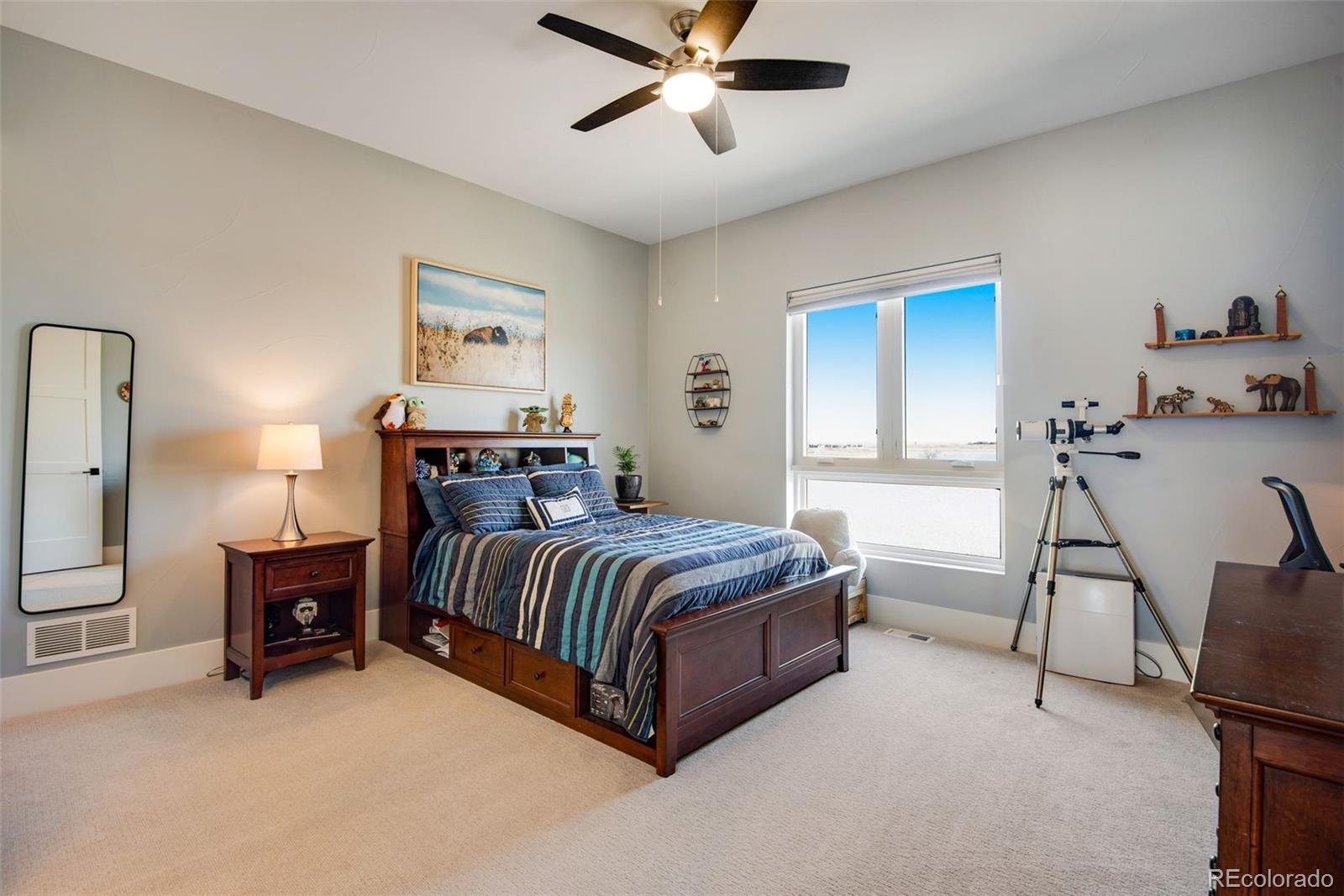 3210 Mallard Creek Road Berthoud, CO 80513 - Photo 36 of 40 a spacious bedroom with a bed and a chandelier