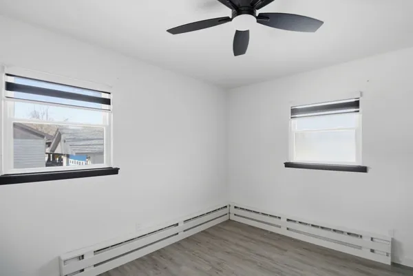 a view of a small space with wooden floor and a window