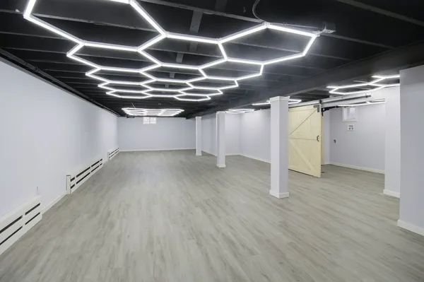 a view of an empty room with wooden floor