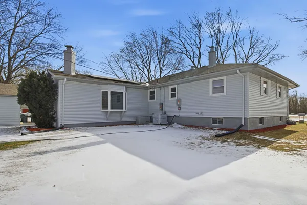 a view of a house with snow on the road