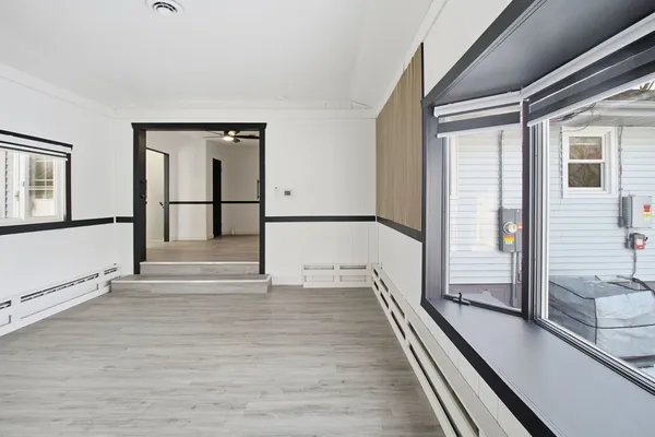 a view of a room with wooden floor