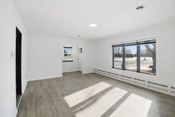 a view of an empty room and a window