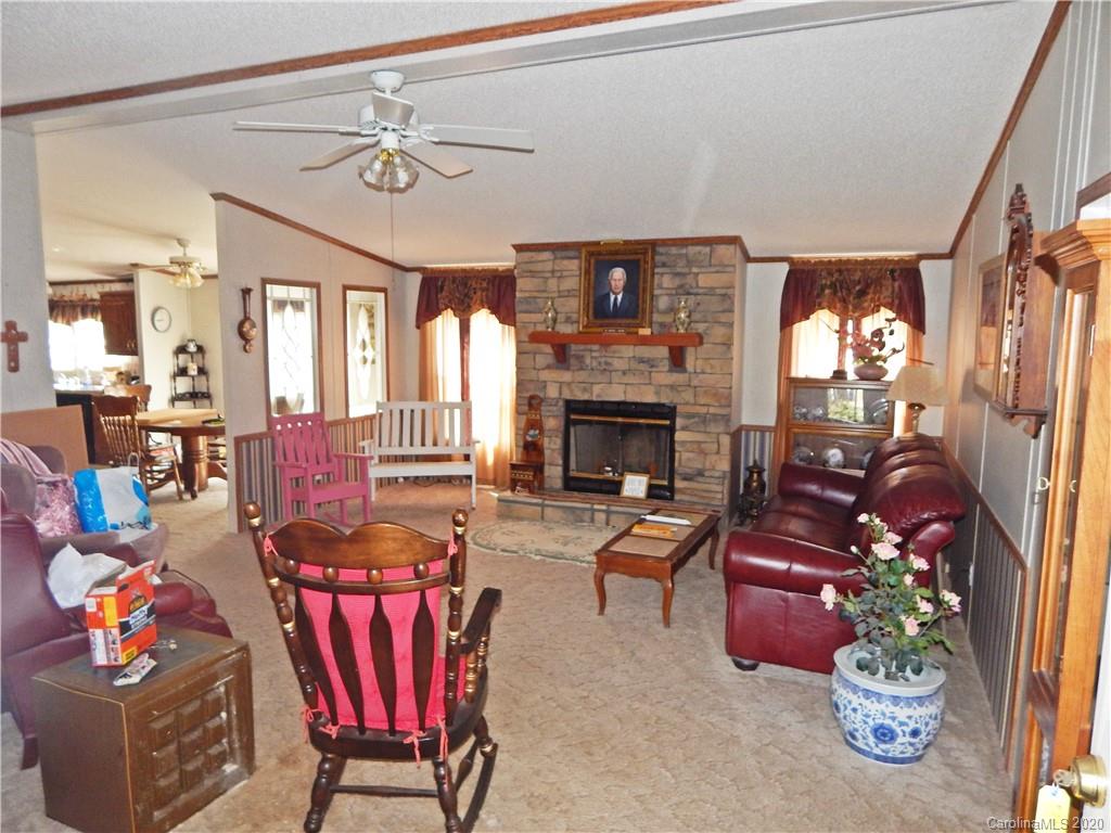 2193 State Rd S-13-106 Pageland, SC 29728 - Photo 4 of 19 a living room with furniture a fireplace and a chandelier
