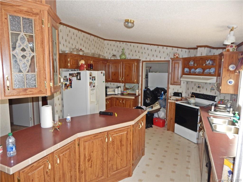 2193 State Rd S-13-106 Pageland, SC 29728 - Photo 6 of 19 a kitchen with stainless steel appliances granite countertop a sink refrigerator and cabinets