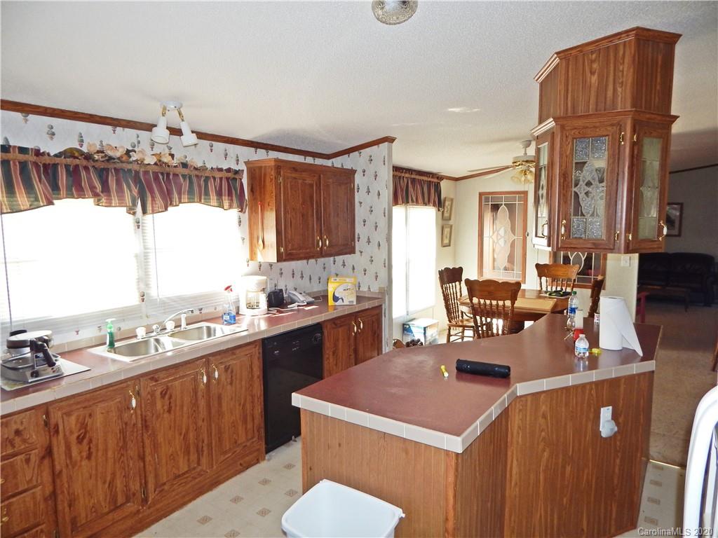2193 State Rd S-13-106 Pageland, SC 29728 - Photo 8 of 19 a kitchen with a sink a counter and chairs