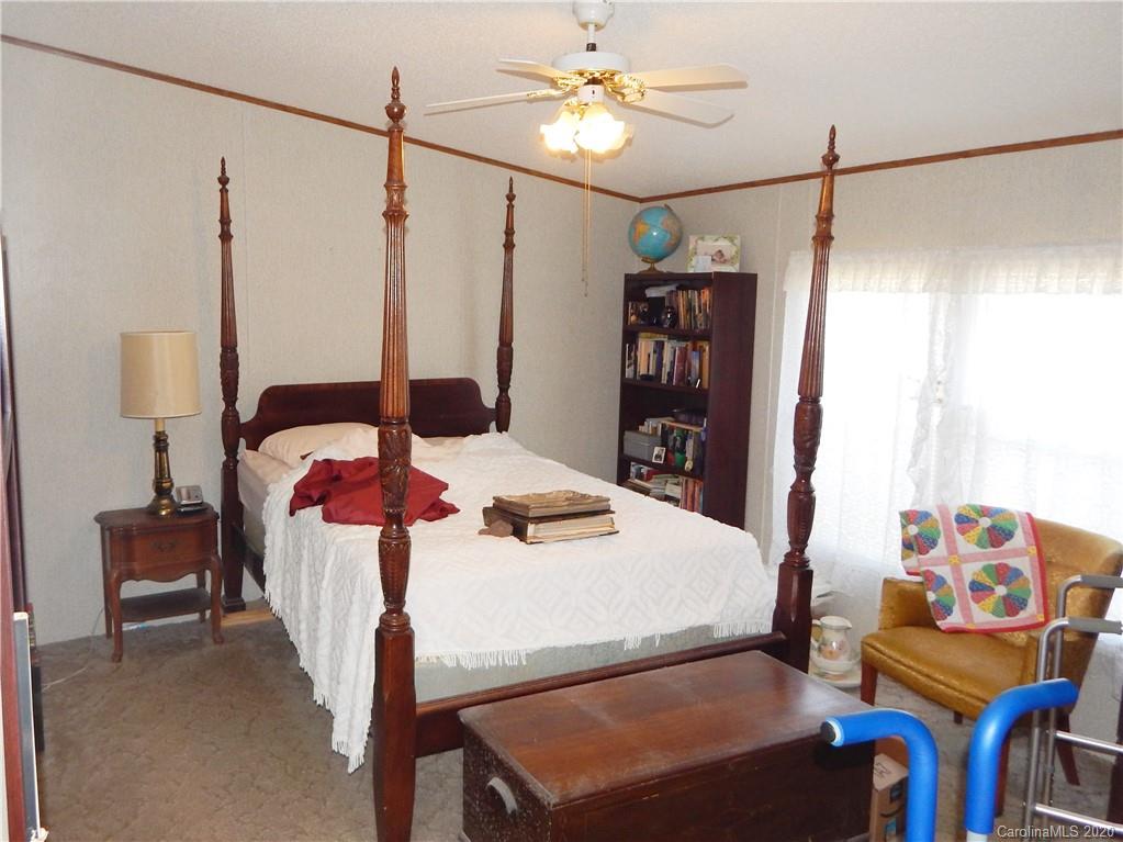 2193 State Rd S-13-106 Pageland, SC 29728 - Photo 9 of 19 a bedroom with a bed and a table in it