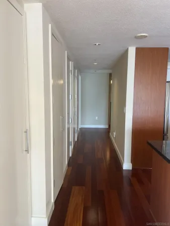 a view of a hallway with wooden floor
