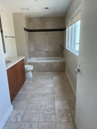 a bathroom with a toilet a sink and a shower