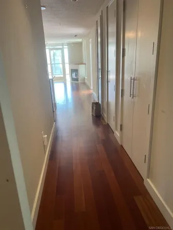 view of a hallway with wooden floor and staircase