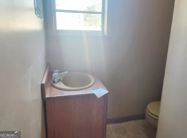 a bathroom with a toilet and a sink
