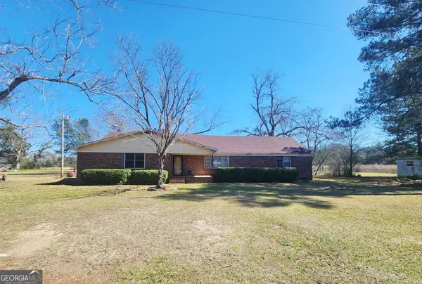 a swimming pool with outdoor seating and yard