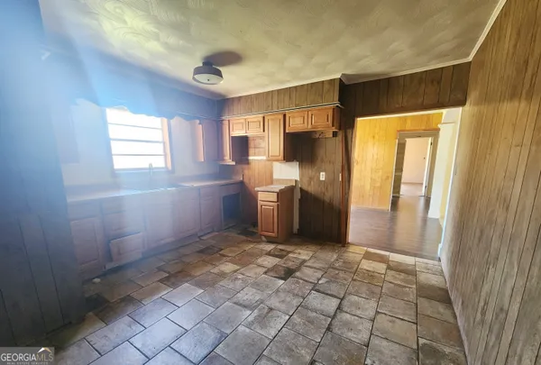 a view of a kitchen with a sink and a window