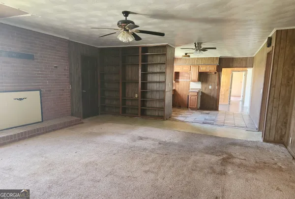 a view of an empty room with a fireplace