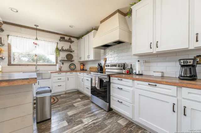 a kitchen with white cabinets and white appliances
