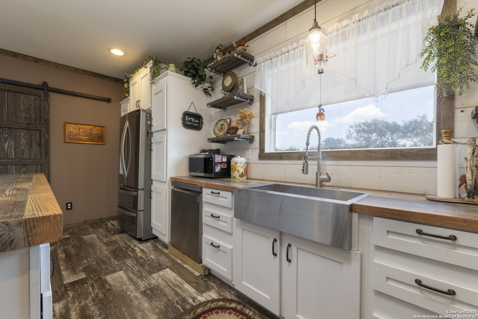 451 Pr 1505 Bandera, TX 78003 - Photo 14 of 43 a kitchen with a sink window and cabinets