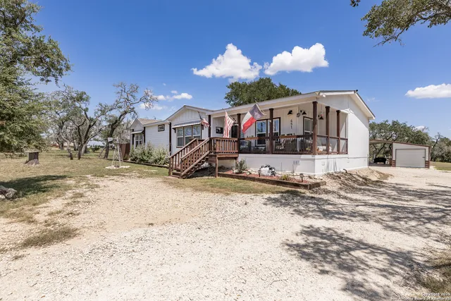 a front view of a house with a yard covered in snow