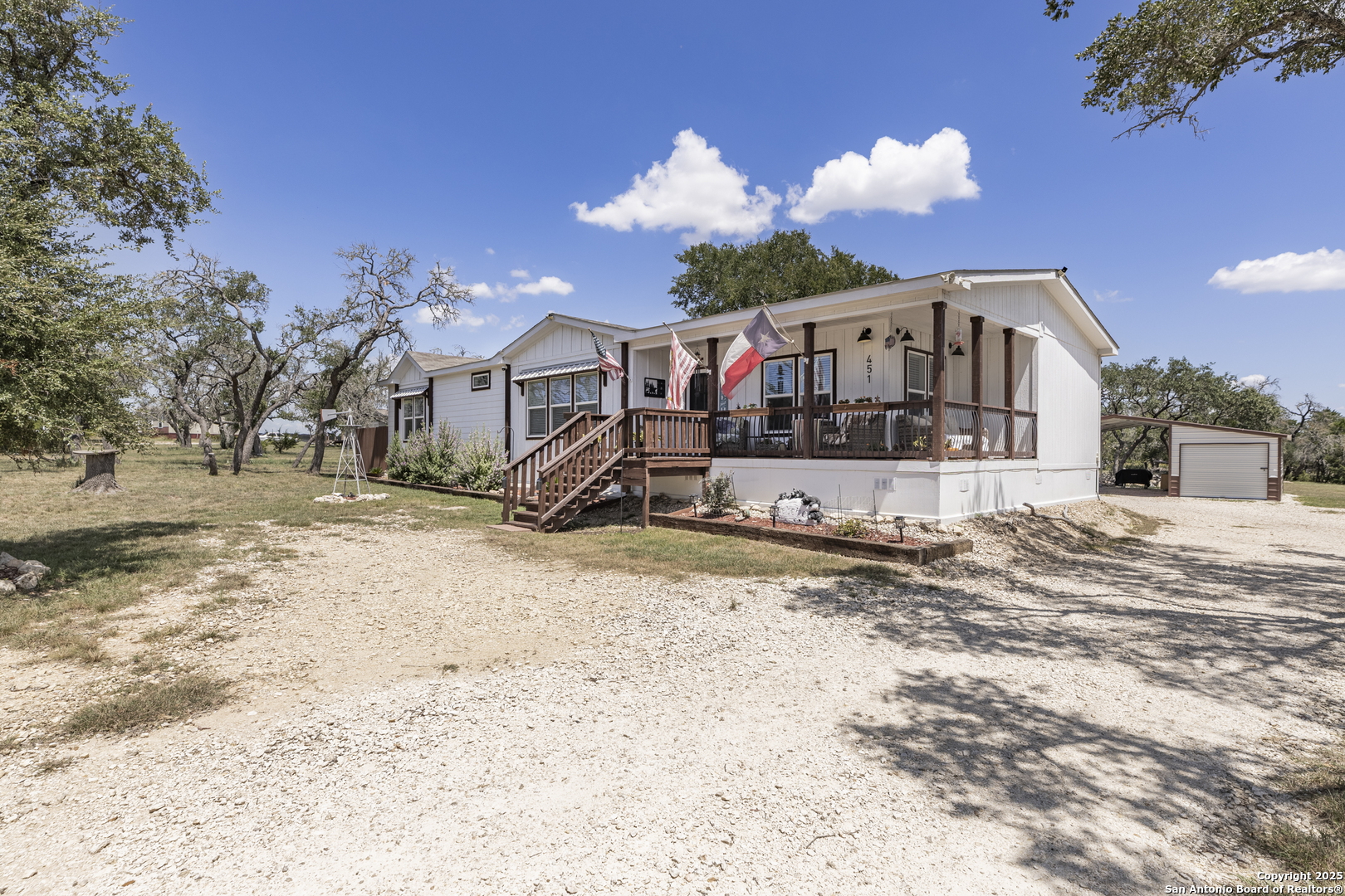 451 Pr 1505 Bandera, TX 78003 - Photo 2 of 43 a front view of a house with a yard covered in snow