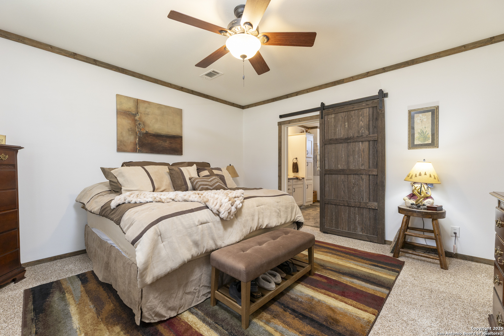 451 Pr 1505 Bandera, TX 78003 - Photo 23 of 43 a bedroom with a bed and a chandelier