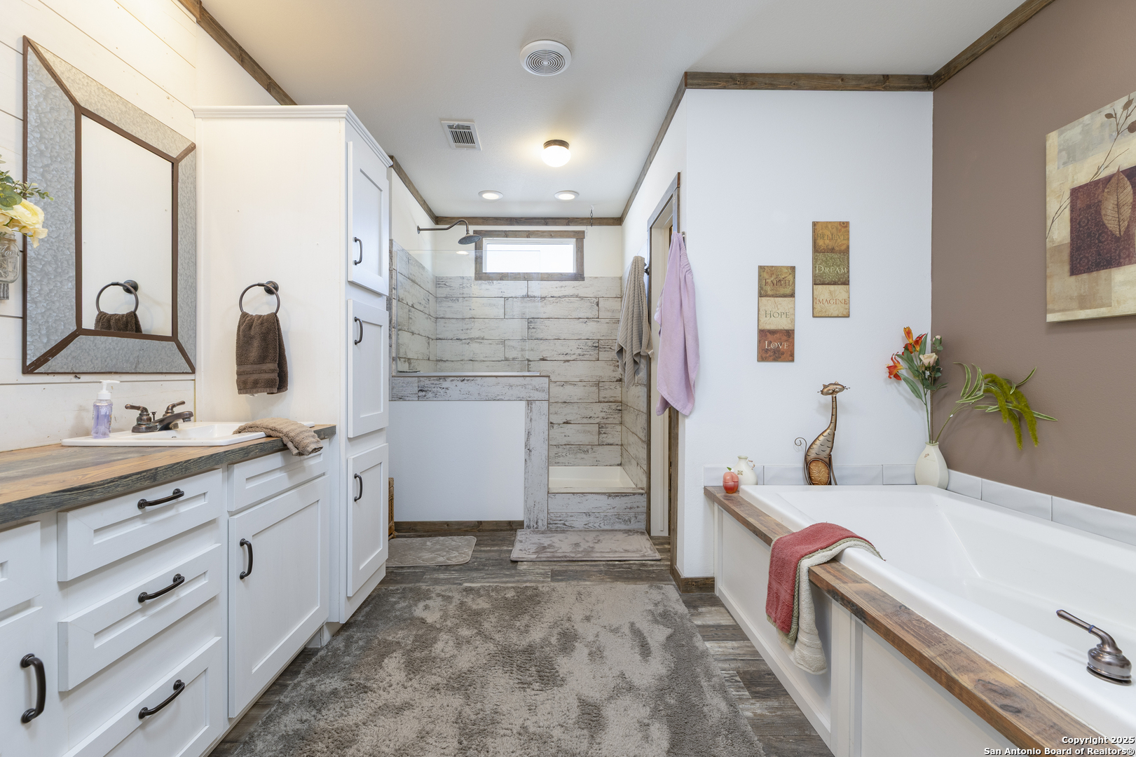 451 Pr 1505 Bandera, TX 78003 - Photo 26 of 43 a bathroom with double vanity sink a mirror and a shower