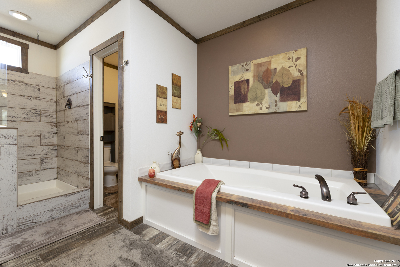 451 Pr 1505 Bandera, TX 78003 - Photo 27 of 43 a bathroom with a bathtub and a shower