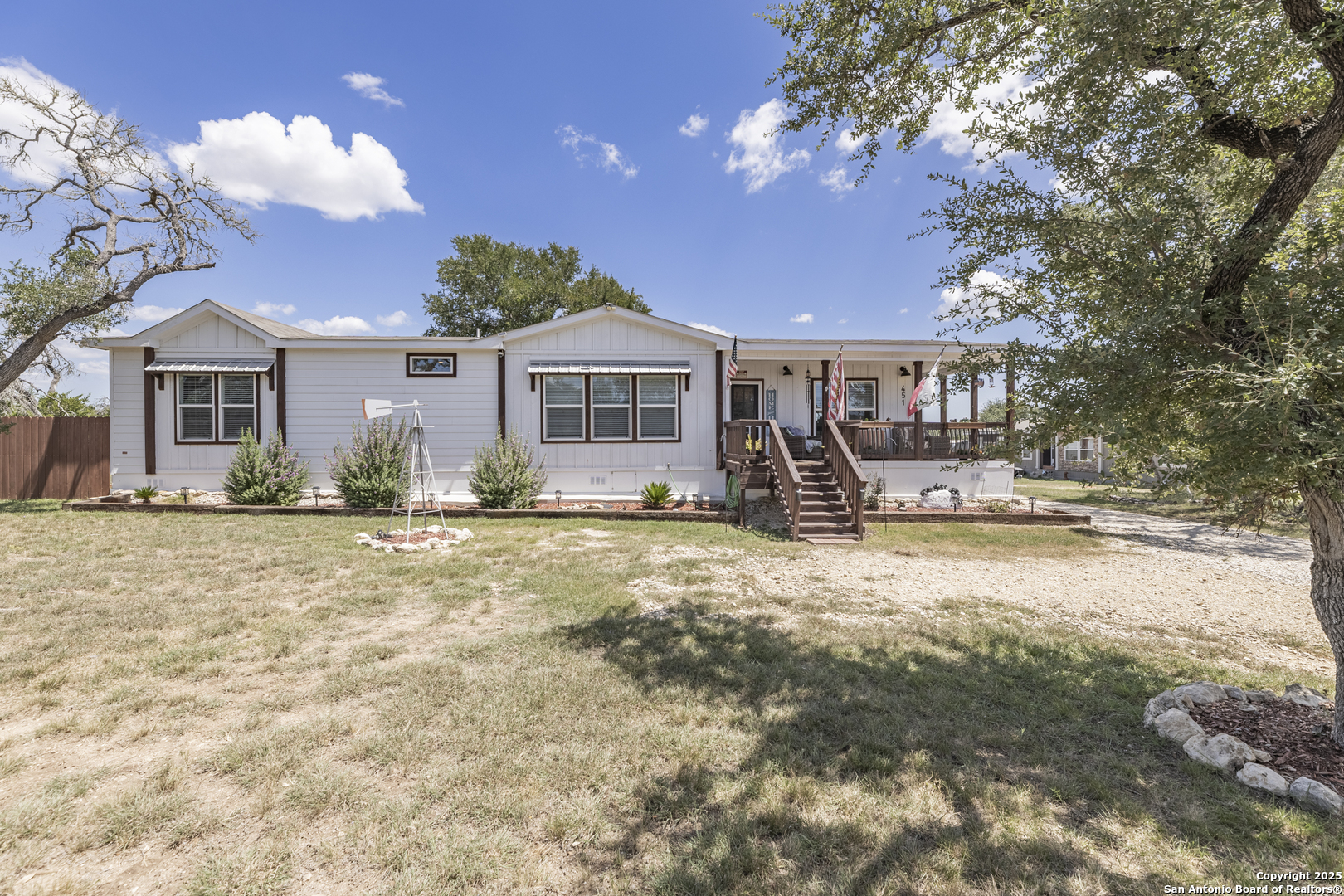 451 Pr 1505 Bandera, TX 78003 - Photo 3 of 43 a front view of a house with a yard and potted plants