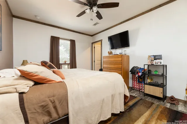 a bedroom with a bed and flat screen tv