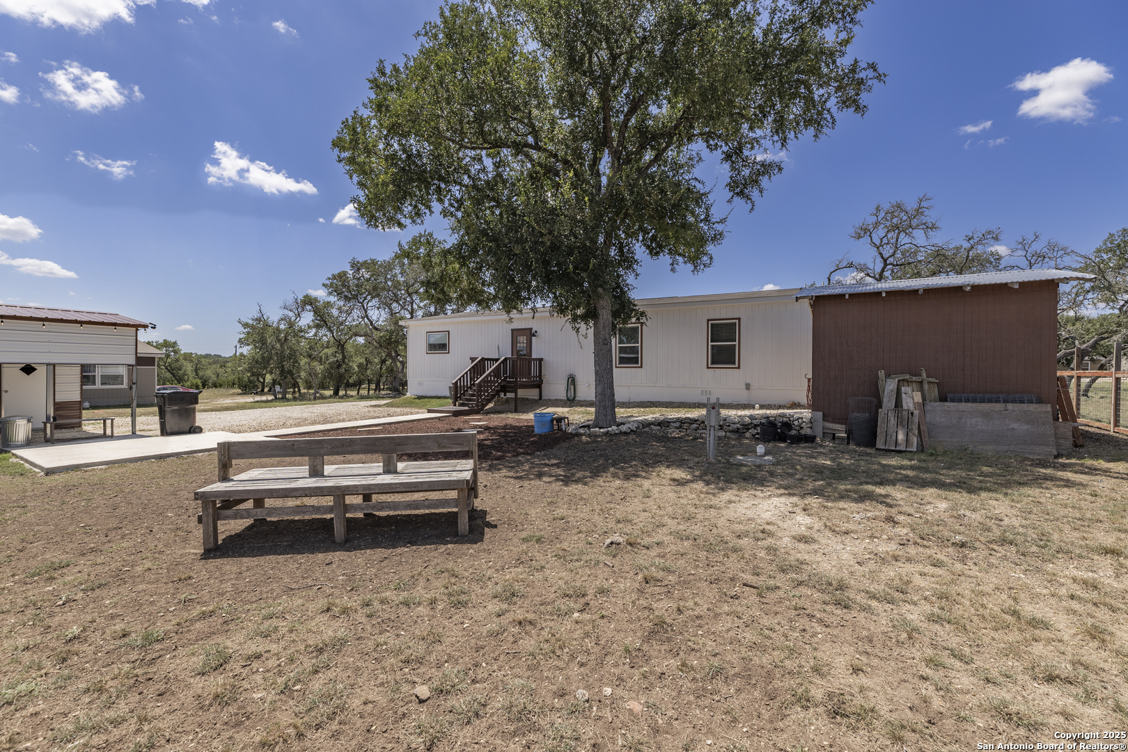 451 Pr 1505 Bandera, TX 78003 - Photo 36 of 43 a backyard of a house with barbeque oven and outdoor seating
