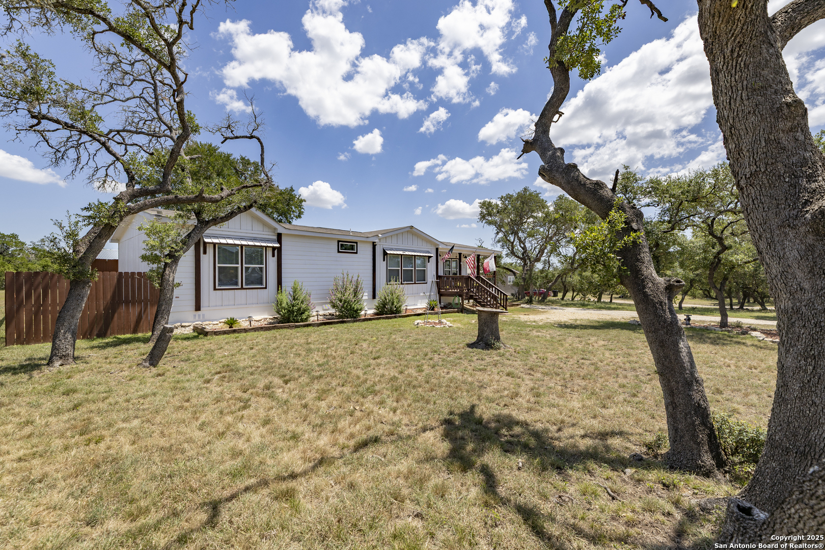 451 Pr 1505 Bandera, TX 78003 - Photo 4 of 43 a tree in front of a house with a large tree