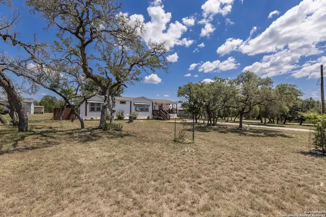 a view of a yard with a tree