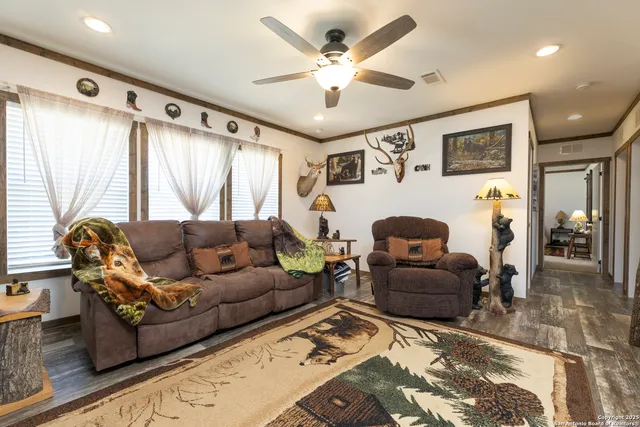 a living room with furniture ceiling fan and a rug